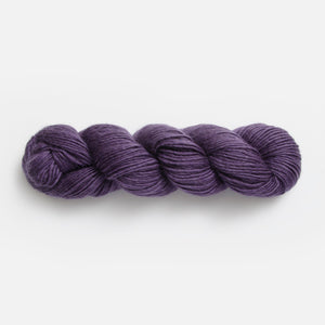 Purple skein of yarn on a white background